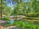Picturesque pond with a charming wooden bridge surrounded by lush greenery at 100 Dacs Ln, Summerville, SC 29483