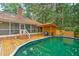 Backyard pool area featuring a wooden deck and storage shed at 100 Dacs Ln, Summerville, SC 29483