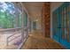 Screened-in porch with wood floors and view of wooded backyard at 100 Dacs Ln, Summerville, SC 29483