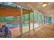 Screened-in porch featuring wood floors, a fan, and backyard pool at 100 Dacs Ln, Summerville, SC 29483