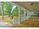 Inviting front porch with wood flooring, supporting columns, a swing, and patriotic flags at 100 Dacs Ln, Summerville, SC 29483