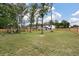 Large backyard with playground and view of the modern white and black trimmed home at 1000 Retreat Ave, Moncks Corner, SC 29461