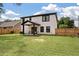Expansive backyard featuring a white two-story home with black trim and a wood fence at 1000 Retreat Ave, Moncks Corner, SC 29461