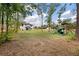 Expansive backyard featuring a playset, grassy lawn, and a view of the two-story home at 1000 Retreat Ave, Moncks Corner, SC 29461