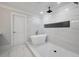 Bright bathroom with a freestanding tub, herringbone floors, and marble-look tile at 1000 Retreat Ave, Moncks Corner, SC 29461