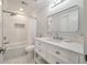 All-white bathroom featuring a tub with a shower, and vanity with framed mirror at 1000 Retreat Ave, Moncks Corner, SC 29461