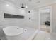 Bright bathroom featuring a tub with a shower and herringbone floors at 1000 Retreat Ave, Moncks Corner, SC 29461