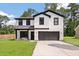 Charming two-story home with modern farmhouse design, white siding, black trim, and inviting front porch at 1000 Retreat Ave, Moncks Corner, SC 29461