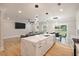 Open concept: the kitchen flows into the living room and dining area with quartz countertops and hardwood floors at 1000 Retreat Ave, Moncks Corner, SC 29461