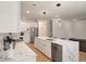 Bright kitchen boasts stainless steel appliances, white cabinets, quartz countertops, and modern pendant lighting at 1000 Retreat Ave, Moncks Corner, SC 29461