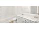 Bathroom featuring double vanity, tiled backsplash, and full bathtub with shower at 1009 Marsh Harrier Dr # Cc3-2-2P, Ravenel, SC 29470