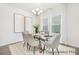 Elegant dining room features a glass table, modern chandelier, and neutral decor, perfect for Gathering meals at 1009 Marsh Harrier Dr # Cc3-2-2P, Ravenel, SC 29470