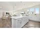 Open-concept kitchen and living area with a large island, modern lighting, and stylish decor at 1009 Marsh Harrier Dr # Cc3-2-2P, Ravenel, SC 29470