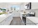 Well-lit kitchen with a view, featuring white cabinetry, quartz countertops, and modern appliances at 1009 Marsh Harrier Dr # Cc3-2-2P, Ravenel, SC 29470