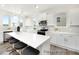 Modern kitchen featuring white cabinets, stainless steel appliances, and a large island with seating at 1009 Marsh Harrier Dr # Cc3-2-2P, Ravenel, SC 29470