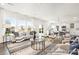 Bright, open-concept living room with large windows and stylish decor; seamlessly connects to the modern kitchen and dining area at 1009 Marsh Harrier Dr # Cc3-2-2P, Ravenel, SC 29470
