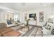 Open-concept living room with stylish furniture, a glass coffee table, and elegant decor at 1009 Marsh Harrier Dr # Cc3-2-2P, Ravenel, SC 29470