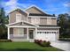 Charming two-story home featuring a covered porch, attached garage, and beautifully landscaped front yard at 101 Indigo Cove Blvd, Summerville, SC 29486