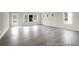 Bright living room with large windows and wood-look flooring at 1060 Marsh Harrier Dr # Cc3-15-8P, Ravenel, SC 29470