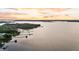 Scenic aerial view with multiple docks stretching into the water and colorful sky at 1085 Harts Bluff Rd, Wadmalaw Island, SC 29487