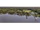 An expansive aerial view shows a waterfront property with docks, lush greenery, and serene water views at 1085 Harts Bluff Rd, Wadmalaw Island, SC 29487
