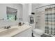 Bright bathroom with vanity, shower-tub, and toiletry storage at 1085 Harts Bluff Rd, Wadmalaw Island, SC 29487