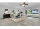 Airy bedroom with a ceiling fan and large windows with waterfront views at 1085 Harts Bluff Rd, Wadmalaw Island, SC 29487