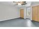 A simple bedroom with two large closets, a window, and a ceiling fan at 1085 Harts Bluff Rd, Wadmalaw Island, SC 29487