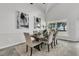 Cozy dining area with a rustic wood table set beneath modern art pieces at 1085 Harts Bluff Rd, Wadmalaw Island, SC 29487