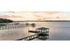 Picturesque waterfront property featuring a private dock and gazebo on calm waters at sunset at 1085 Harts Bluff Rd, Wadmalaw Island, SC 29487
