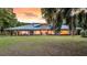 Spacious brick home with a green metal roof, large windows and a well-maintained lawn at 1085 Harts Bluff Rd, Wadmalaw Island, SC 29487
