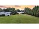 A charming cottage with a lush green lawn and a detached garage at 1085 Harts Bluff Rd, Wadmalaw Island, SC 29487