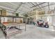Spacious garage interior, including a lawn mower and storage, providing ample space for vehicles and tools at 1085 Harts Bluff Rd, Wadmalaw Island, SC 29487