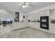 Bright kitchen features white cabinetry, modern appliances, and access to a living room with a stone fireplace at 1085 Harts Bluff Rd, Wadmalaw Island, SC 29487
