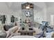 Spacious living room boasts a stone fireplace, vaulted ceilings, and plenty of natural light at 1085 Harts Bluff Rd, Wadmalaw Island, SC 29487