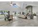 Open floor plan integrates the living and dining areas, highlighted by a stone fireplace at 1085 Harts Bluff Rd, Wadmalaw Island, SC 29487