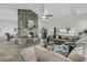 Open-concept living room featuring a grand stone fireplace, large windows, and water views at 1085 Harts Bluff Rd, Wadmalaw Island, SC 29487