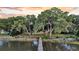 Beautiful waterfront home with a private dock surrounded by lush trees and serene waters at 1085 Harts Bluff Rd, Wadmalaw Island, SC 29487