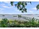 Picturesque view of a pier with a gazebo extending into the water, surrounded by green foliage at 1085 Harts Bluff Rd, Wadmalaw Island, SC 29487
