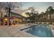 Stunning backyard featuring a pool, sun loungers, outdoor kitchen, and covered patio for ultimate relaxation at 1098 Reserve Ln, Awendaw, SC 29429