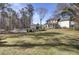 Expansive backyard with a pool, outdoor living space, and mature trees at 1098 Reserve Ln, Awendaw, SC 29429