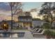 Stunning backyard featuring a sparkling pool, lounge chairs, and a meticulously maintained lawn, perfect for relaxation at 1098 Reserve Ln, Awendaw, SC 29429