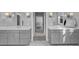 Dual sink bathroom vanity with stone countertop and a peek into a bedroom at 1098 Reserve Ln, Awendaw, SC 29429