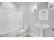 This bathroom features a shower-tub combo, pedestal sink, and a tiled floor at 1098 Reserve Ln, Awendaw, SC 29429