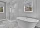 Bright bathroom featuring a glass enclosed shower and free standing bathtub at 1098 Reserve Ln, Awendaw, SC 29429