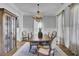 Elegant dining room with chandelier, wood table and cabinet is perfect for hosting dinner parties at 1098 Reserve Ln, Awendaw, SC 29429