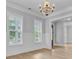 Formal dining room featuring wainscoting, large windows, and an elegant chandelier at 1098 Reserve Ln, Awendaw, SC 29429