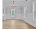 Dining room with wainscoting, large windows, and an elegant chandelier, providing a bright and airy space at 1098 Reserve Ln, Awendaw, SC 29429