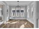 Bright dining room with hardwood floors, abundant natural light, and modern chandelier at 1098 Reserve Ln, Awendaw, SC 29429