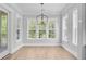 The dining room has wood floors, neutral walls, and a modern chandelier at 1098 Reserve Ln, Awendaw, SC 29429